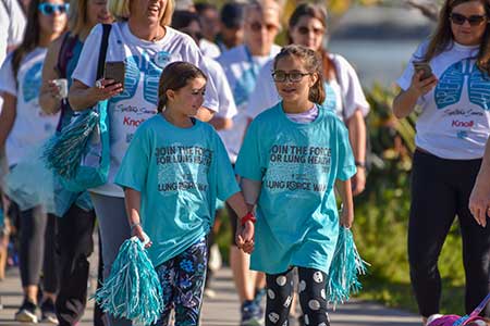 two girls with pom poms at a LUNG FORCE Walk