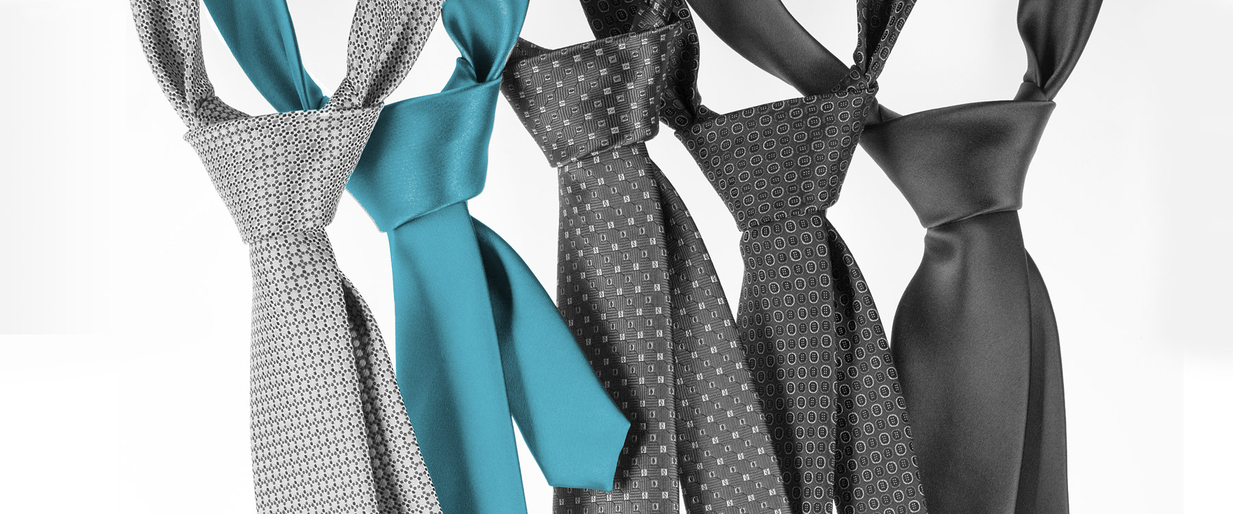 group of black, white, gray and turquoise neckties.