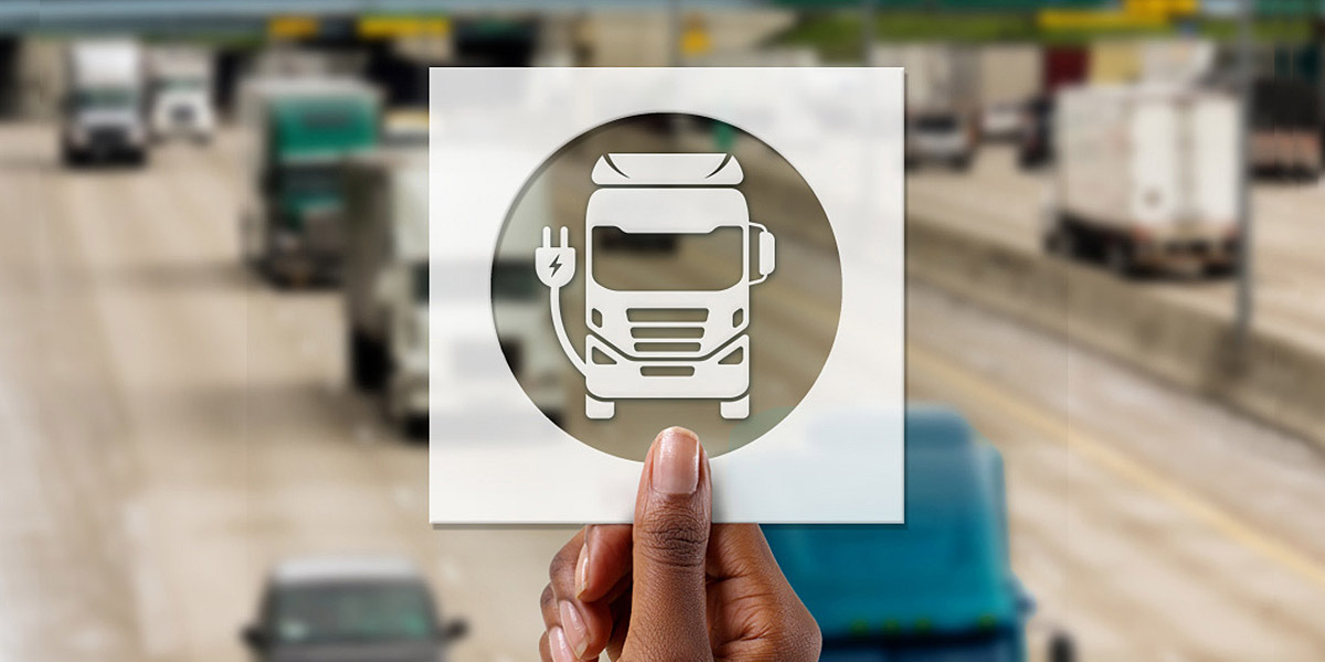 hand holding card with electric truck icon cutout